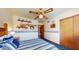 This charming bedroom includes a ceiling fan, carpeting, and bright lighting at 6720 W Mcrae Way, Glendale, AZ 85308