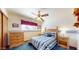 This bedroom offers a ceiling fan, a comfortable bed, and a window for natural light at 6720 W Mcrae Way, Glendale, AZ 85308