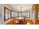 Sunlit dining room featuring wood shutters, a chandelier, and hardwood floors for elegant meals at 6720 W Mcrae Way, Glendale, AZ 85308