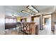 Open-concept kitchen with breakfast bar, tile floors, and white appliances at 6720 W Mcrae Way, Glendale, AZ 85308