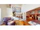Open-concept living room with wrought iron staircase and built-in shelving at 6720 W Mcrae Way, Glendale, AZ 85308