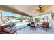 Covered patio featuring an outdoor dining table and comfortable seating around the sparkling pool at 6720 W Mcrae Way, Glendale, AZ 85308