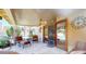 Cozy covered patio space with comfortable seating, fan, and view of pool through sliding glass doors at 6720 W Mcrae Way, Glendale, AZ 85308