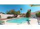 Lovely pool area featuring lush landscaping, a rock waterfall, and a serene atmosphere at 6720 W Mcrae Way, Glendale, AZ 85308