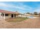 Backyard view with pool, grass area, and covered patio at 7120 W Columbine Dr, Peoria, AZ 85381