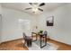 Bright bedroom with hard flooring has large window and modern ceiling fan at 7120 W Columbine Dr, Peoria, AZ 85381