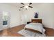 Clean bedroom featuring wood floors, neutral walls, and a cozy rug to enjoy at 7120 W Columbine Dr, Peoria, AZ 85381