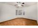 Bright bedroom features laminate flooring, modern ceiling fan, and a large window at 7120 W Columbine Dr, Peoria, AZ 85381