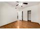 Bedroom with wood-look flooring features closet and door to other rooms at 7120 W Columbine Dr, Peoria, AZ 85381