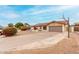 Charming home featuring a Spanish tile roof, desert landscaping, and a basketball hoop above the garage at 7120 W Columbine Dr, Peoria, AZ 85381