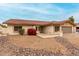 A well-maintained, single story home featuring desert landscaping, neutral paint, and dark framed windows at 7120 W Columbine Dr, Peoria, AZ 85381