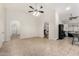 Open-concept living room featuring tile floors and arched doorways to other rooms in the house at 7120 W Columbine Dr, Peoria, AZ 85381