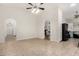 Spacious living room featuring tile floors, neutral walls and arched doorways to other rooms at 7120 W Columbine Dr, Peoria, AZ 85381
