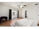 Cozy primary bedroom with wood floors, slider to the backyard, and ensuite bathroom at 7120 W Columbine Dr, Peoria, AZ 85381