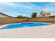 Backyard pool with concrete surround and clear blue skies above at 7120 W Columbine Dr, Peoria, AZ 85381