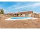 Backyard pool with white fencing is surrounded by rocks at 7120 W Columbine Dr, Peoria, AZ 85381