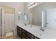Bathroom featuring dual sinks, and a large mirror reflecting a bright, clean space at 7726 E Baseline Rd # 156, Mesa, AZ 85209