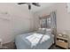 Comfortable bedroom featuring natural light, a window with curtains, and sliding closet doors at 7726 E Baseline Rd # 156, Mesa, AZ 85209