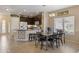 Well-lit kitchen offering a granite island with bar stools and stainless appliances adjoining dining area at 7726 E Baseline Rd # 156, Mesa, AZ 85209