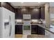 Modern kitchen showcasing dark wood cabinetry, stainless appliances, and a practical layout at 7726 E Baseline Rd # 156, Mesa, AZ 85209