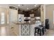 Contemporary kitchen with a large granite island and breakfast bar, enhanced with decorative elements at 7726 E Baseline Rd # 156, Mesa, AZ 85209