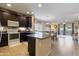 Open kitchen featuring a large island with granite countertops and stainless appliances; dining room in view at 7726 E Baseline Rd # 156, Mesa, AZ 85209