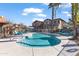 Community pool with lounge chairs and umbrellas at 7726 E Baseline Rd # 156, Mesa, AZ 85209