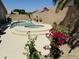 Backyard pool with spa and desert landscaping including bougainvillea and sunflowers at 7908 W Harmony Ln, Peoria, AZ 85382