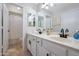 Bathroom with double sinks, white cabinetry, and modern black fixtures at 7908 W Harmony Ln, Peoria, AZ 85382