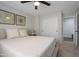 Cozy bedroom featuring a ceiling fan, modern wall art and a sliding door closet at 7908 W Harmony Ln, Peoria, AZ 85382