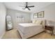 Relaxing bedroom with a neutral color palette, a large window, and modern art at 7908 W Harmony Ln, Peoria, AZ 85382