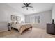 Bedroom featuring a ceiling fan, window with louvers and modern furnishings at 7908 W Harmony Ln, Peoria, AZ 85382
