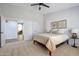 Bedroom with ceiling fan, art work on the wall and warm neutral colors at 7908 W Harmony Ln, Peoria, AZ 85382