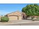 Charming home with a well-maintained lawn and a large three-car garage and beautiful mature landscaping at 7908 W Harmony Ln, Peoria, AZ 85382