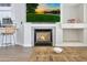 Close up of the fireplace featuring a TV screen, a coffee table, and bar stool seating at 7908 W Harmony Ln, Peoria, AZ 85382
