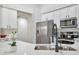 Beautiful kitchen with stainless steel appliances and sleek white countertops at 7908 W Harmony Ln, Peoria, AZ 85382