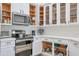Updated kitchen featuring stainless steel appliances, sleek countertops, and white cabinetry at 7908 W Harmony Ln, Peoria, AZ 85382