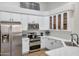 Stylish kitchen with stainless steel appliances and white cabinets for a modern look at 7908 W Harmony Ln, Peoria, AZ 85382