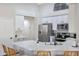 Bright kitchen with white countertops, stainless steel appliances, and bar stool seating at the counter at 7908 W Harmony Ln, Peoria, AZ 85382