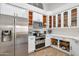 Bright kitchen with stainless steel appliances and white cabinetry with a good-sized refrigerator at 7908 W Harmony Ln, Peoria, AZ 85382