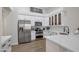 Well-lit kitchen showcasing stainless steel appliances and bright white cabinets at 7908 W Harmony Ln, Peoria, AZ 85382