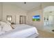 Comfortable main bedroom with large windows and neutral decor, leading to en-suite bathroom at 7908 W Harmony Ln, Peoria, AZ 85382
