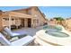 Inviting backyard oasis with pool, spa, covered patio, and comfortable lounge seating at 7908 W Harmony Ln, Peoria, AZ 85382