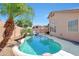 Inviting pool featuring a rock waterfall, lush palms, lounge chairs and blue skies in a private backyard at 7908 W Harmony Ln, Peoria, AZ 85382