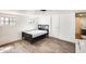 Bedroom featuring a bed, two windows, wood flooring, and access to ensuite bathroom at 8218 S 7Th St # 163, Phoenix, AZ 85042