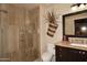 Bathroom features a vanity with a framed mirror, a toilet, and a walk-in shower at 8406 E Calle Buena Vis, Scottsdale, AZ 85255