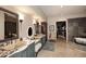 Luxurious bathroom with custom vanity, standalone tub, and walk-in closet at 8406 E Calle Buena Vis, Scottsdale, AZ 85255
