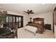 Beautiful bedroom with a ceiling fan, plantation shutters, and a luxurious bed at 8406 E Calle Buena Vis, Scottsdale, AZ 85255