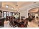 Formal dining room features a large wooden table and chandelier, perfect for entertaining at 8406 E Calle Buena Vis, Scottsdale, AZ 85255
