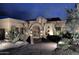 Elegant home exterior at night featuring desert landscaping and decorative lighting at 8406 E Calle Buena Vis, Scottsdale, AZ 85255